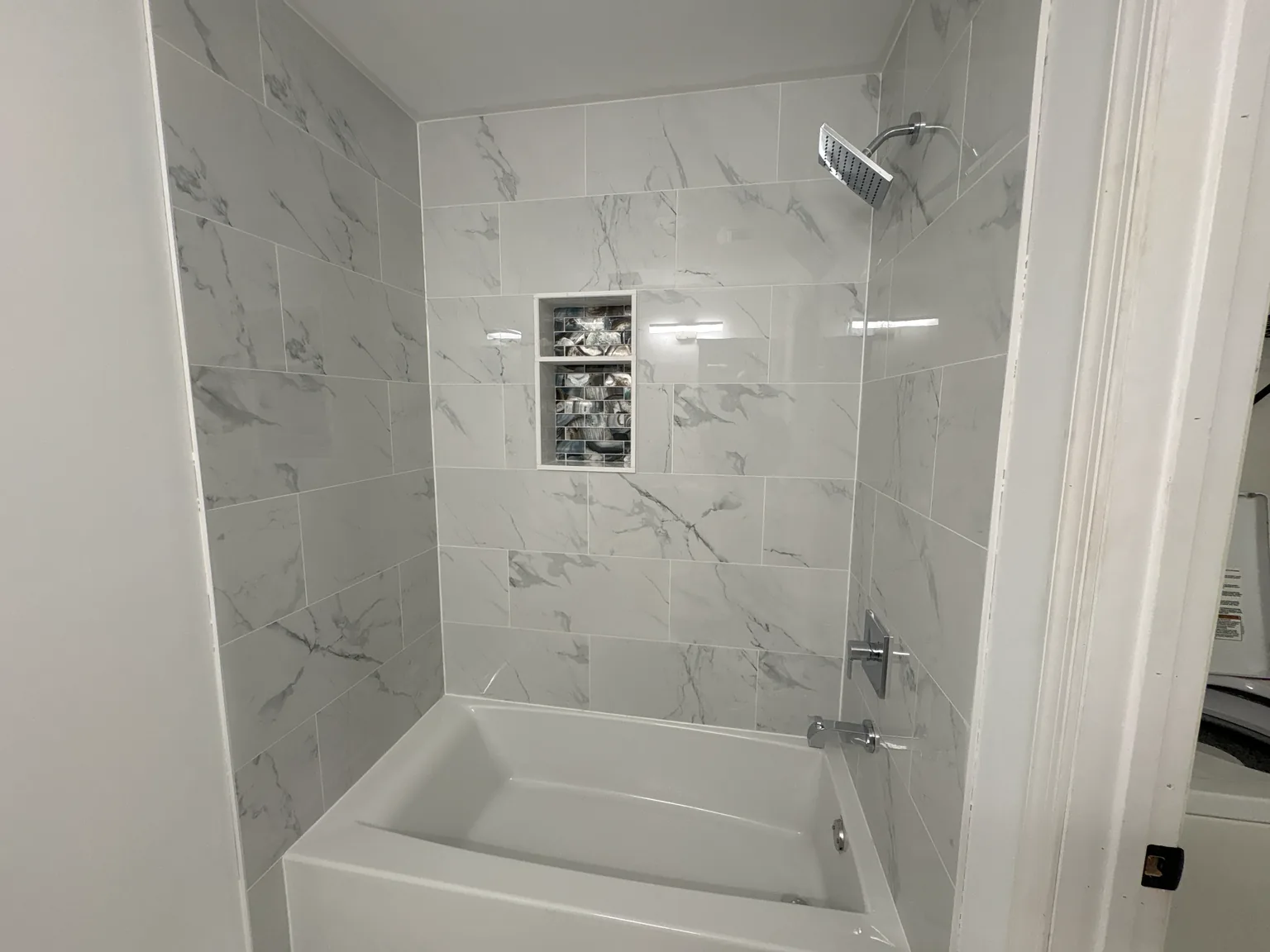 White kitchen remodel with quartz counters, shaker cabinets and stainless appliances